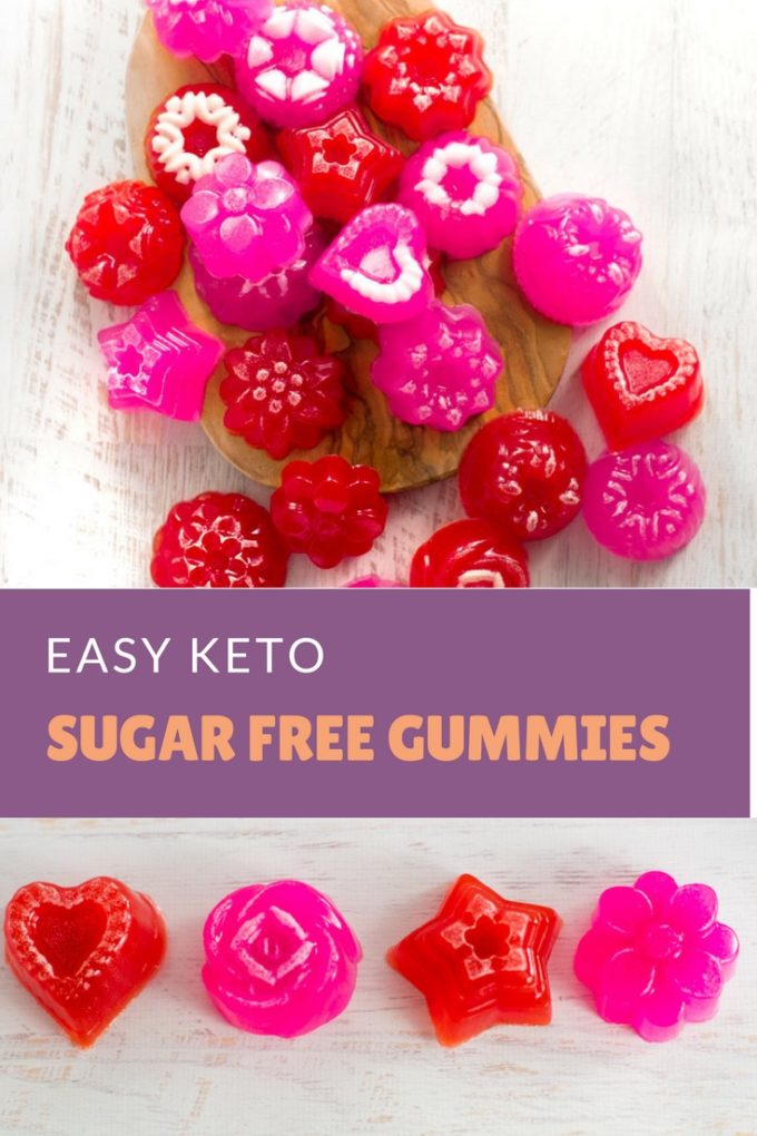 red and pink keto gummy candies on a wooden board