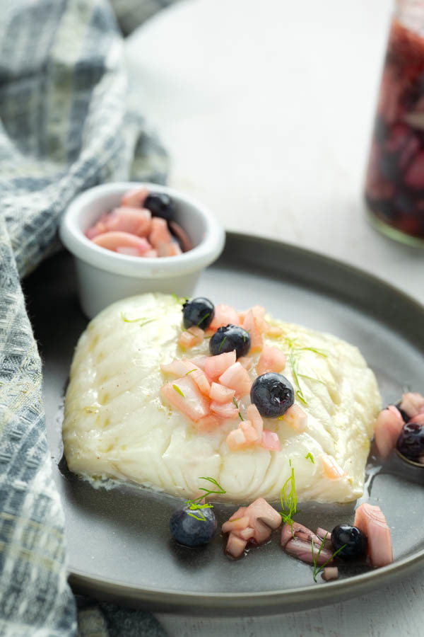 baked cod with blueberry and shallots over the top