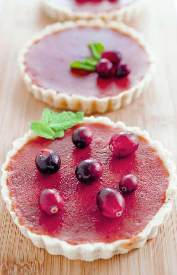 cranberry curd tarts on a wooden board